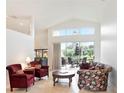 Bright living room with high ceilings and views of the outdoor patio seating area at 3023 Bent Creek Dr, Valrico, FL 33596