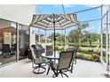 Relaxing screened-in patio with a table and chairs overlooking a peaceful pond at 3023 Bent Creek Dr, Valrico, FL 33596