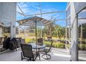 Relaxing screened patio with dining set and beautiful views of the lake at 3023 Bent Creek Dr, Valrico, FL 33596