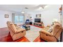 Bright living room with hardwood floors, ceiling fan, and neutral decor at 3078 Pointer Dr, Palm Harbor, FL 34683