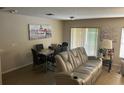 The seating area seamlessly connects to the dining space, with modern furniture and stylish decor at 3132 Royal Tuscan Ln, Valrico, FL 33594