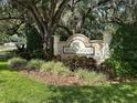The welcoming Wedgewood community sign with lush landscaping, beautiful trees, and well-maintained greenery at 3132 Royal Tuscan Ln, Valrico, FL 33594