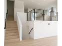 Modern staircase with sleek black railings and an open concept view into the kitchen at 3820 Pompano Se Dr, St Petersburg, FL 33705
