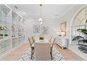 Elegant dining room with decorative lighting, a table for six, and built-in shelves at 3982 Wellington Pkwy, Palm Harbor, FL 34685