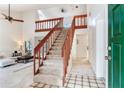 Inviting foyer showcasing staircase with wood railing, tile flooring, and access to the living room at 4802 W Dryad St, Tampa, FL 33629