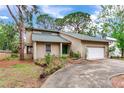 Charming home featuring a well-maintained lawn, lush landscaping, and a welcoming front entrance at 4802 W Dryad St, Tampa, FL 33629