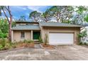 Charming home with attached garage and well-maintained lawn, lush landscaping, and a welcoming front entrance at 4802 W Dryad St, Tampa, FL 33629