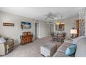 Cozy living room with a dining table and a mounted television for relaxed living and entertainment at 4900 Brittany S Dr # 808, St Petersburg, FL 33715
