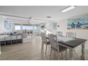 A combined living and dining room with a beautiful water view in the background at 500 Treasure Island Cswy # 704, Treasure Island, FL 33706