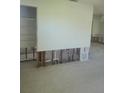 Renovation of the living room with exposed studs and terrazzo floors at 5105 Bonito Dr, New Port Richey, FL 34652