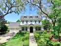 Stunning three-story home showcases manicured landscaping, a symmetrical design, and a charming front porch at 5318 Candler View Dr, Lithia, FL 33547