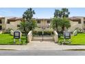 Well-maintained condo complex featuring lush landscaping, palm trees, and clear signage for easy navigation at 7540 Sunshine Skyway S Ln # 219, St Petersburg, FL 33711
