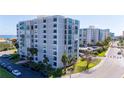 Beautiful condo building with large windows, mature landscaping, and ample parking for residents and guests at 855 Bayway Blvd # 703, Clearwater Beach, FL 33767