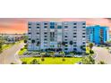 A beautiful condominium building with stunning architecture, lush landscaping, and convenient parking at 855 Bayway Blvd # 703, Clearwater Beach, FL 33767