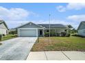 Attractive one-story home with a garage, solar panels, and a well-kept front lawn at 9413 Stonewall Ln, New Port Richey, FL 34655