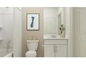 Bright bathroom featuring white vanity, framed art, and shower with curtain at 10210 Purple Leaf Ct, Riverview, FL 33578