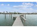 Waterfront home featuring a private wooden dock that extends into the tranquil bay waters at 11340 5Th E St, Treasure Island, FL 33706