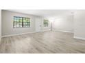Bright, spacious living room features updated flooring and two large windows at 13250 Ridge Rd # 4B3, Largo, FL 33778