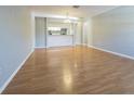 Spacious living room featuring wood floors and an open view to the kitchen and breakfast bar at 13608 S Village Dr # 6203, Tampa, FL 33618