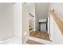 Staircase landing featuring hardwood floors, white walls, and light fixtures at 1476 Harbour Walk Rd, Tampa, FL 33602