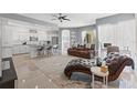 Spacious living room with an open-concept design, tile flooring, and modern finishes, adjacent to the kitchen at 15428 Atwater Dr, Brooksville, FL 34604