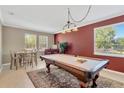 Stylish game room featuring a pool table, accent wall, and natural light at 15635 Starling Water, Lithia, FL 33547