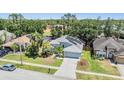 Aerial view of a well-maintained home with solar panels and a large, fenced-in backyard at 18013 Palm Breeze Dr, Tampa, FL 33647