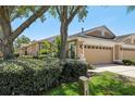 Charming home with a two-car garage, mature landscaping, and a well-maintained lawn at 19129 Lake Audubon Dr, Tampa, FL 33647