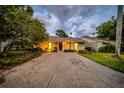 Inviting single-story home with a well-maintained lawn and mature trees at 20 Windrush Bay Dr # 20, Tarpon Springs, FL 34689