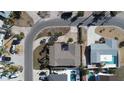 Aerial view of a house, with a large roof, nearby trees, and a large concrete parking area at 2015 Dolphin S Blvd, St Petersburg, FL 33707