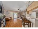 Open living area with wood floors, sliding glass doors to the backyard, and bar seating at 2153 Catalina N Dr, Clearwater, FL 33763