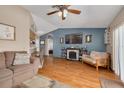 Cozy living room featuring a fireplace, mounted TV, and access to the kitchen and backyard at 2153 Catalina N Dr, Clearwater, FL 33763