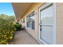 Close up view of exterior of unit 8 with storm door, windows and landscaping at 2286 Norwegian Dr # 8, Clearwater, FL 33763