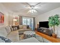 Inviting living room with modern furnishings, a plush rug, and a large entertainment center at 2400 Winding Creek Blvd # 24-102, Clearwater, FL 33761