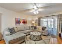 Comfortable living room with a large sectional sofa, stylish ottoman, and plenty of natural light at 2400 Winding Creek Blvd # 24-102, Clearwater, FL 33761