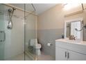 Modern bathroom features sleek glass-door shower, vanity, and tiled walls at 2511 Bay Blvd # B, Indian Rocks Beach, FL 33785