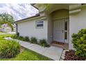 Inviting front entrance featuring a well-maintained garden and a charming 'Home Sweet Home' doormat at 25830 Crippen Dr, Land O Lakes, FL 34639