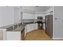 Well-lit kitchen features granite countertops, stainless steel appliances, and tiled flooring at 25830 Crippen Dr, Land O Lakes, FL 34639
