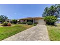 Well-maintained single-story home with a stone driveway and a manicured front lawn at 2800 54Th N St, St Petersburg, FL 33710