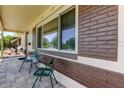 Cozy front porch showcasing a large window, brick detail, and comfortable seating for relaxation at 2800 54Th N St, St Petersburg, FL 33710