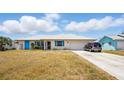 Charming single-story home with bright blue shutters and an attached two-car garage at 2810 9Th St, Englewood, FL 34224