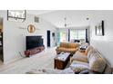 Cozy living room featuring vaulted ceilings, neutral paint, tile flooring, and comfortable sofas at 2810 9Th St, Englewood, FL 34224