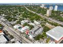 An aerial view of a modern neighborhood with mature trees near a highway and bay at 3012 W Barcelona St # 7, Tampa, FL 33629