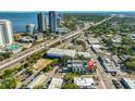 An aerial view of a neighborhood featuring a modern home and commercial buildings near the bay at 3012 W Barcelona St # 7, Tampa, FL 33629