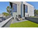 Stylish patio featuring modern outdoor furniture, grill, and artificial turf at 3012 W Barcelona St # 7, Tampa, FL 33629