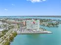 Aerial view of condo building, showing the large parking lot and water surrounding the building at 31 Island Way # 1507, Clearwater Beach, FL 33767
