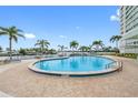 Outdoor swimming pool with a view of the water and palm trees at 31 Island Way # 1507, Clearwater Beach, FL 33767