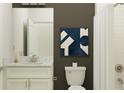 Modern bathroom featuring white subway tile, white vanity with marble countertop, and dark accent wall at 31781 Griffin Sands Ln, San Antonio, FL 33576