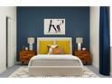 Stylish bedroom with blue accent wall, mid-century modern nightstands, and a king-size bed at 31781 Griffin Sands Ln, San Antonio, FL 33576