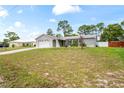 Attractive single-story home featuring an attached garage, a driveway, and verdant front lawn at 3353 Montano Ave, Spring Hill, FL 34609